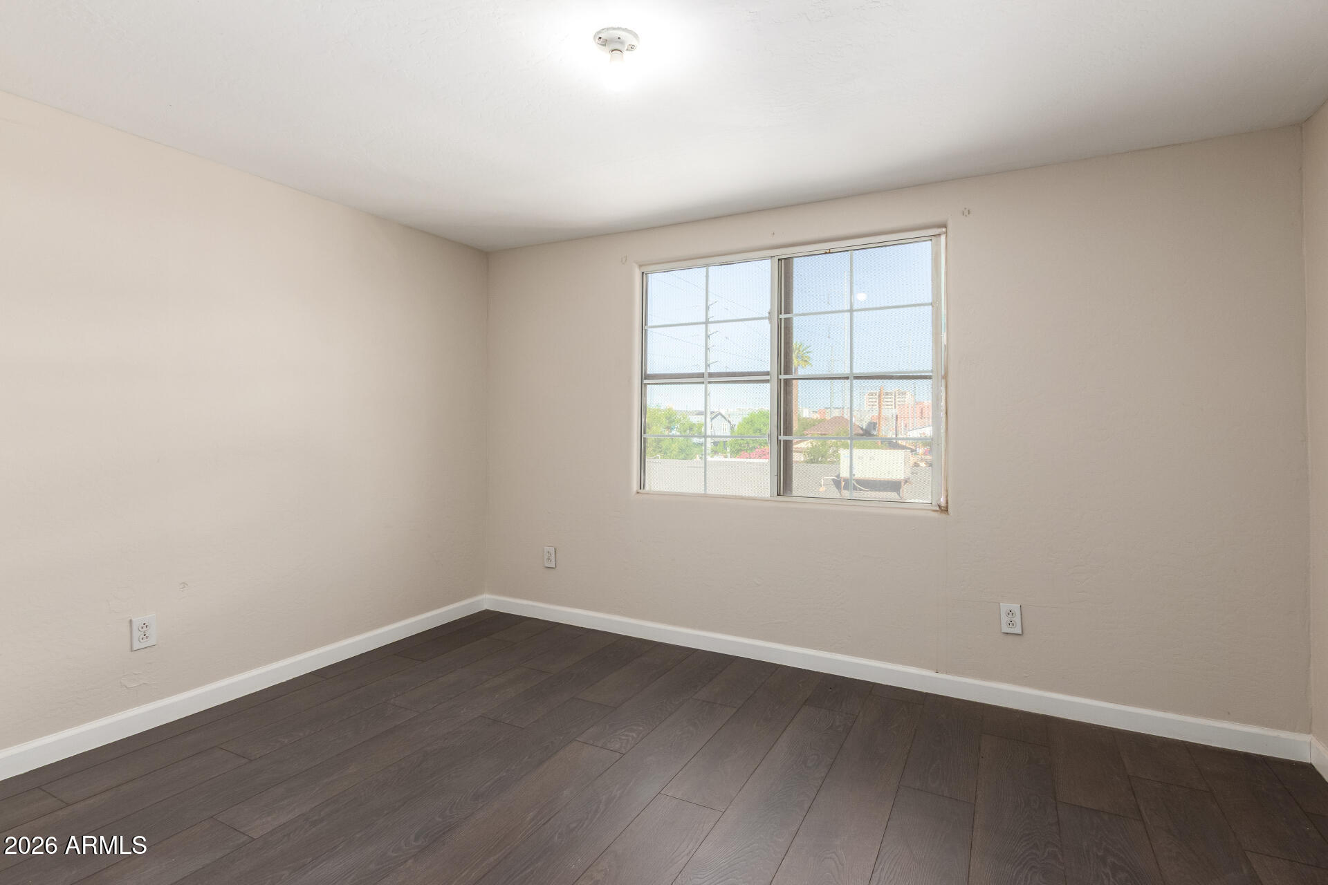 819 South 3rd Avenue Phoenix, AZ 85003 - Photo 34 of 45 an empty room with wooden floor and windows