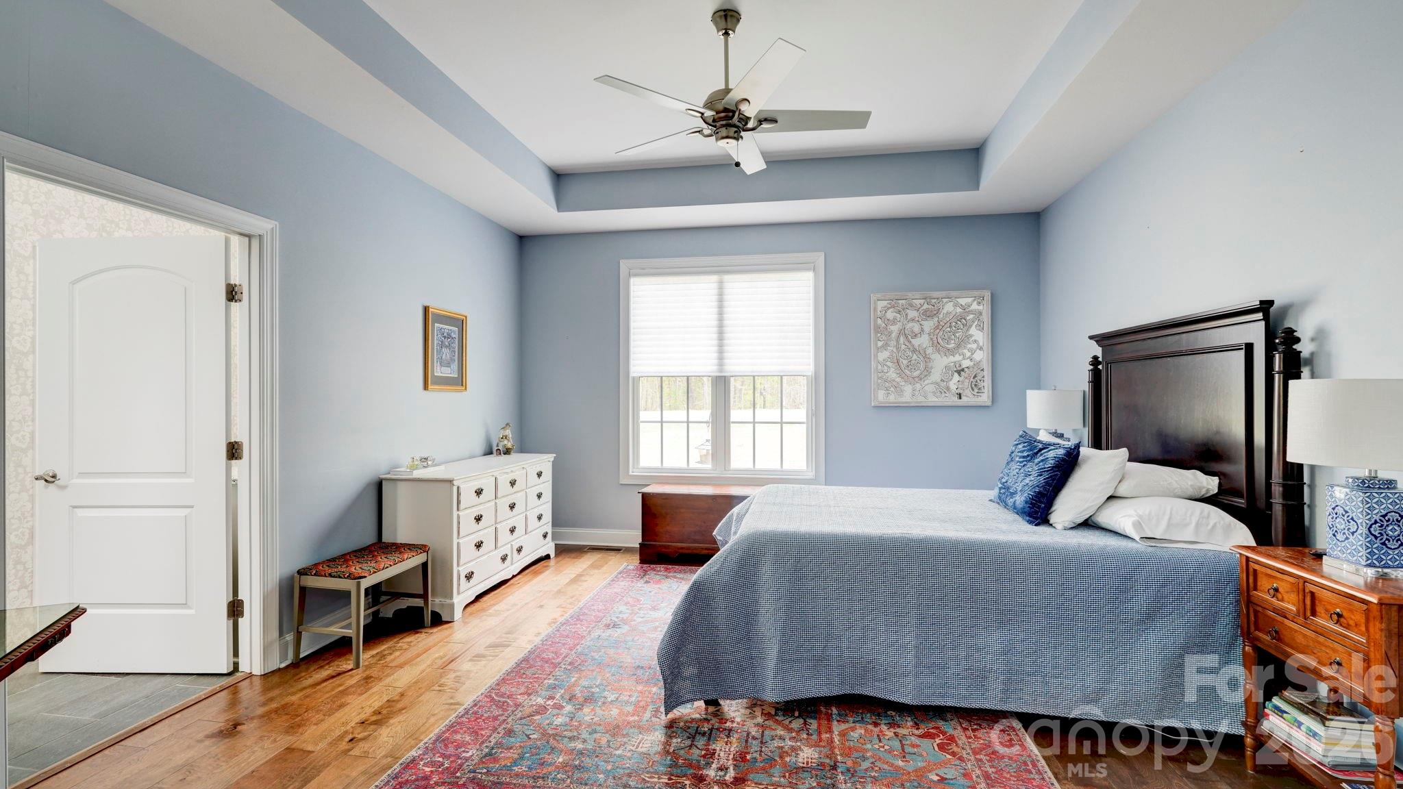 1775 Enochville Road Kannapolis, NC 28081 - Photo 13 of 41 a bedroom with a large bed and a chandelier