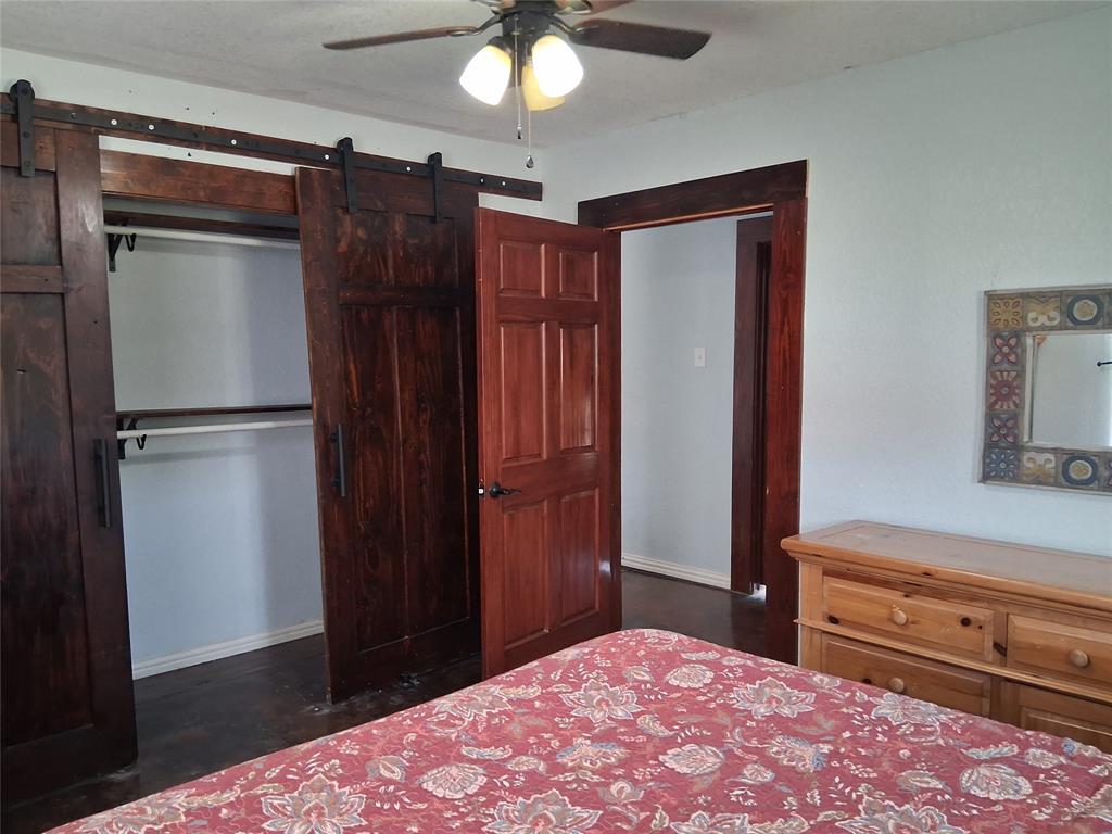 1584 Kelly Road, Unit B Aledo, TX 76008 - Photo 11 of 24 a bedroom with a bed and a flat tv screen on dresser