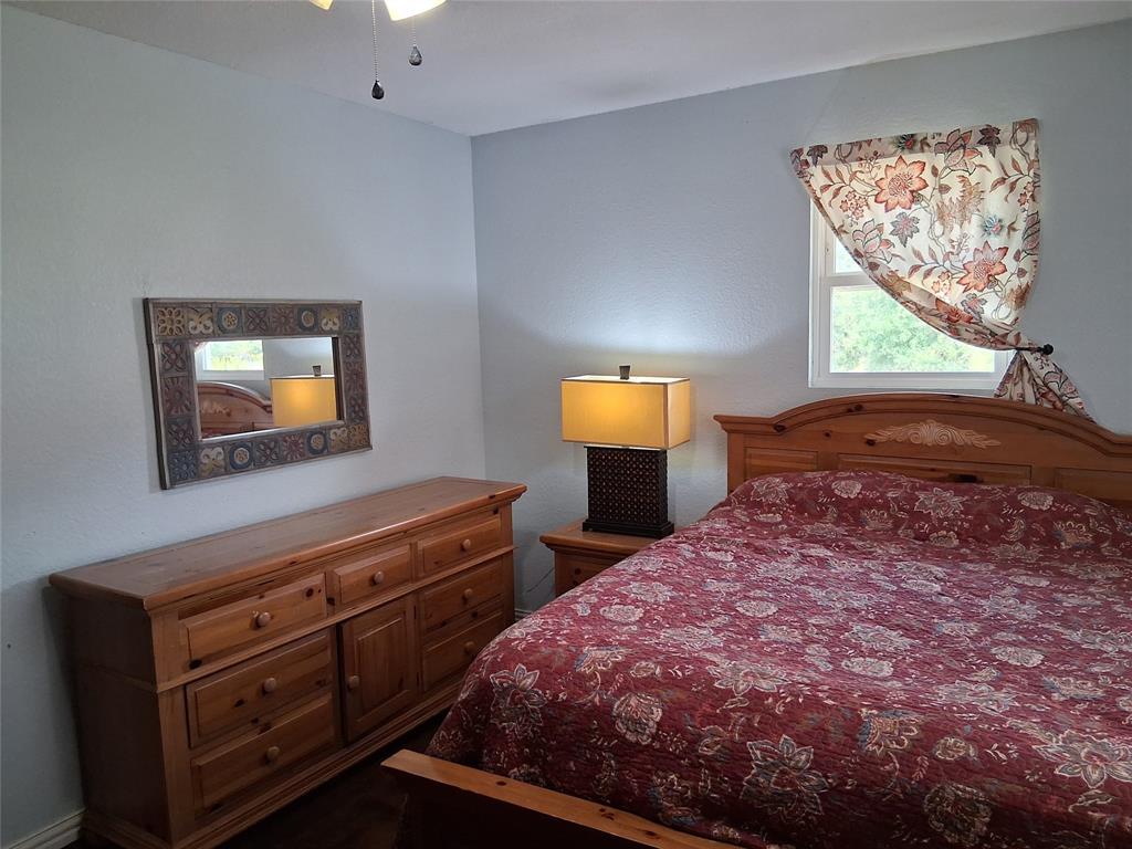 1584 Kelly Road, Unit B Aledo, TX 76008 - Photo 12 of 24 a bedroom with a bed and a flat screen tv