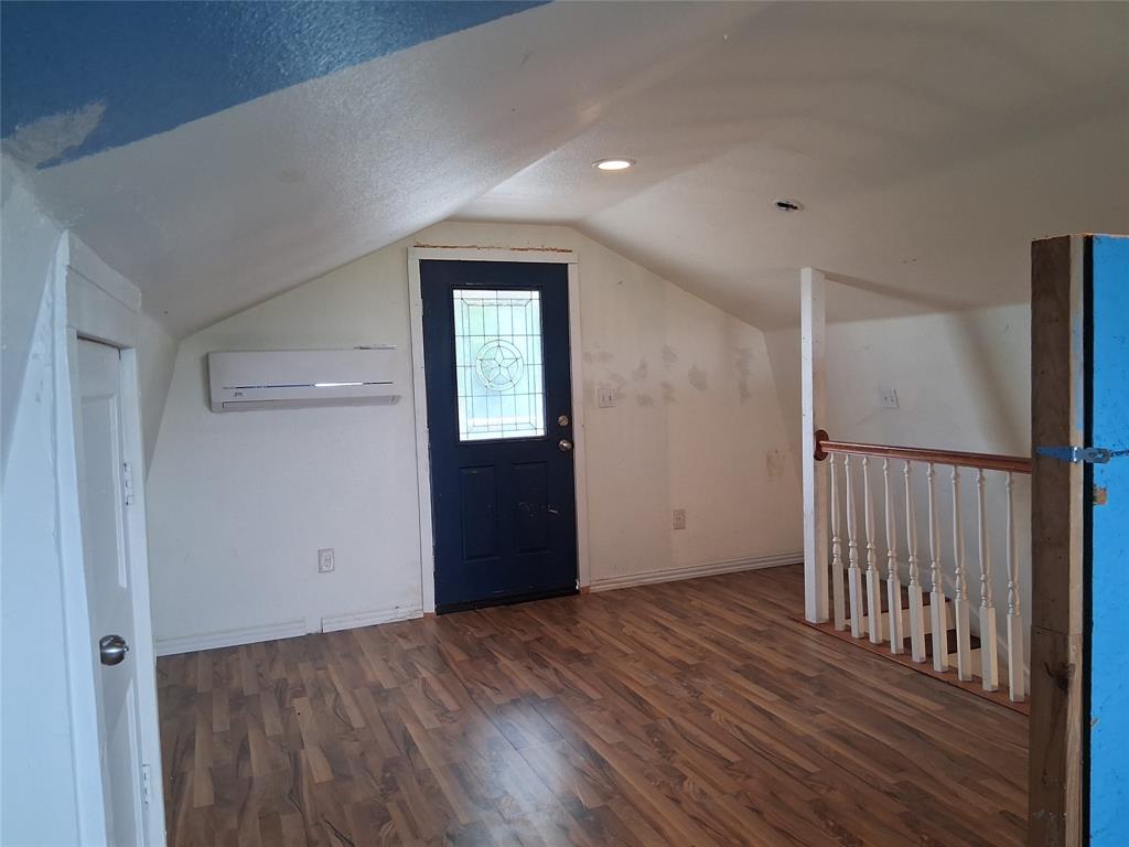1584 Kelly Road, Unit B Aledo, TX 76008 - Photo 16 of 24 a view of an empty room with wooden floor and a window