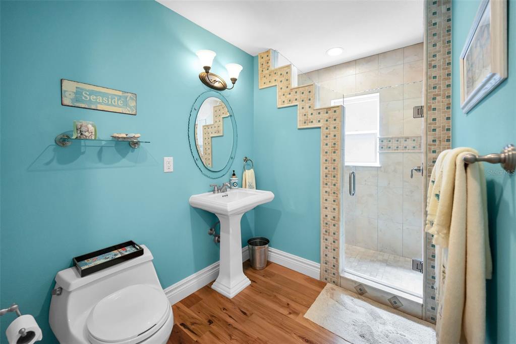 13303 Gulf Lane Madeira Beach, FL 33708 - Photo 27 of 42 a bathroom with a toilet sink and shower