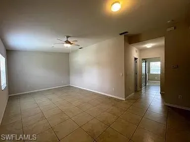 a view of a hallway with wooden floor and chandelier