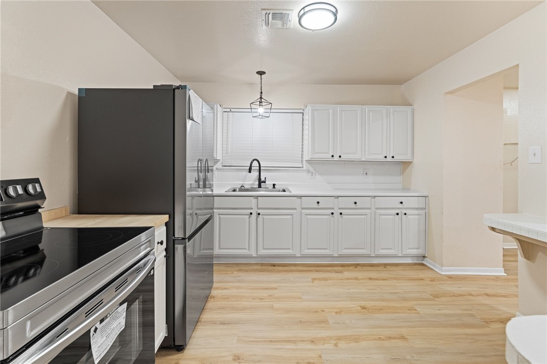 5921 Riley Drive Corpus Christi, TX 78412 - Photo 7 of 20 a kitchen with a sink stainless steel appliances and cabinets