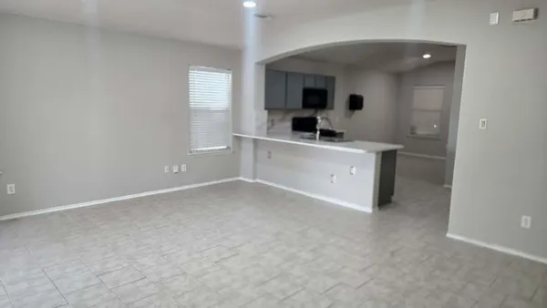 a kitchen with a sink cabinets and a window