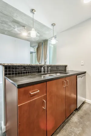 a kitchen with stainless steel appliances granite countertop a sink and a refrigerator
