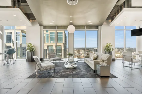 a living room with furniture and a large window