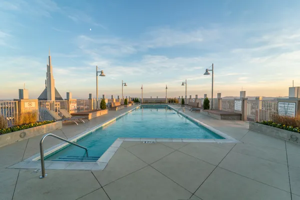 a view of a swimming pool with outdoor seating