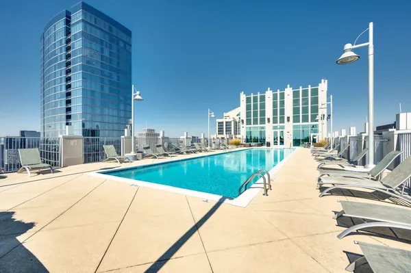 a view of a swimming pool and lounge chairs