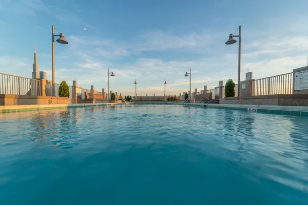 a view of swimming pool outdoor seating and city view