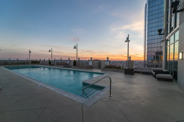a view of roof deck with a barbeque grill and couches