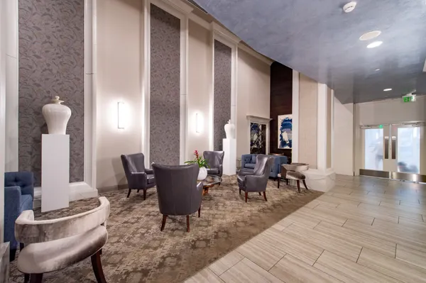 a living room with furniture and large windows