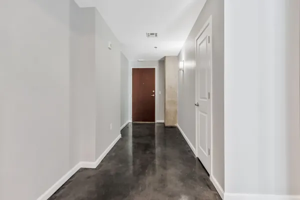 a view of a hallway with wooden floor