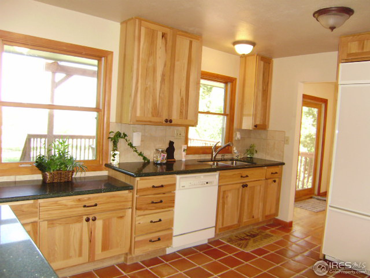 9568 Phillips Road Lafayette, CO 80026 - Photo 11 of 18 a kitchen with stainless steel appliances granite countertop a sink a stove and a refrigerator