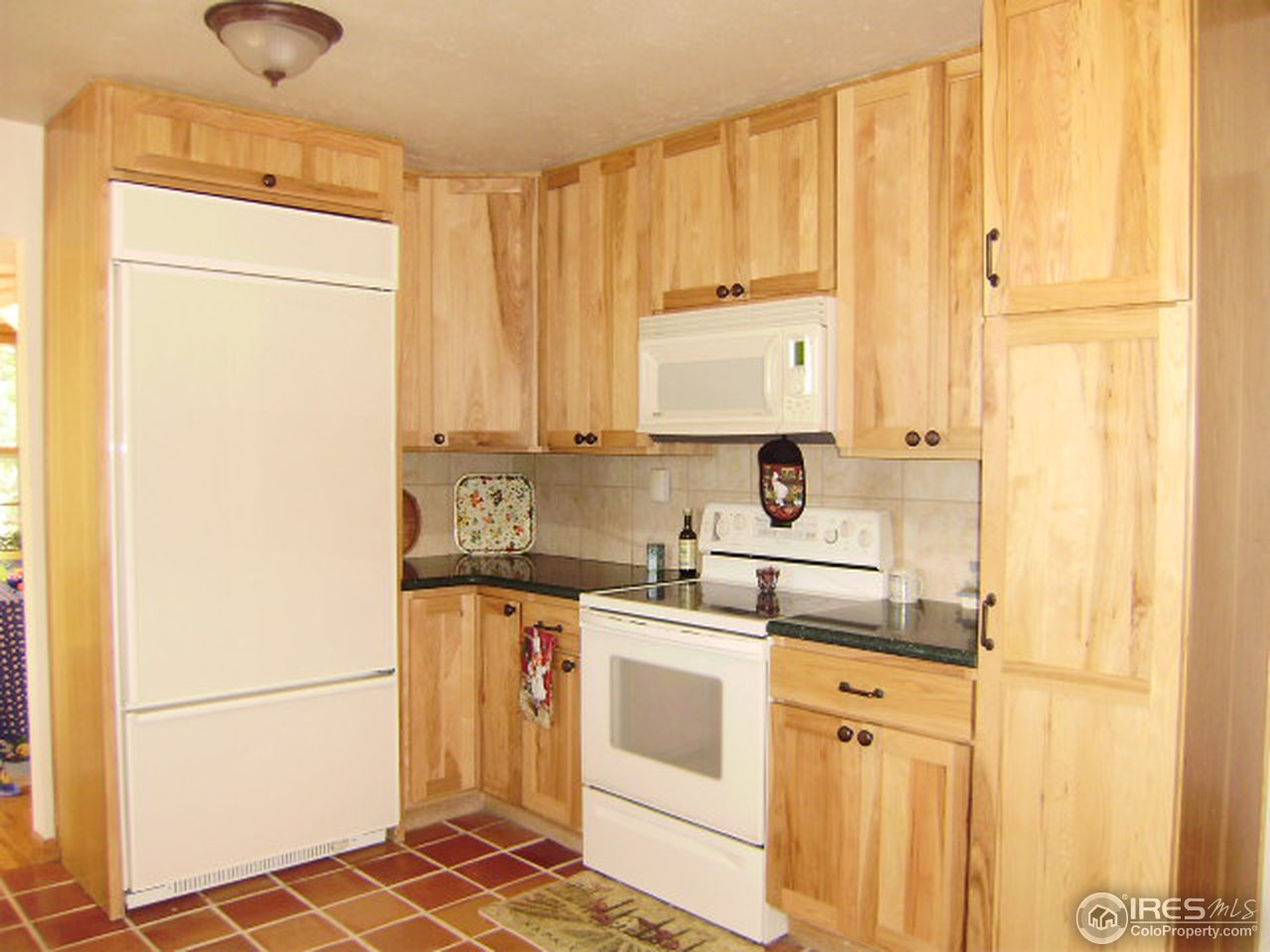 9568 Phillips Road Lafayette, CO 80026 - Photo 12 of 18 a kitchen with stainless steel appliances a stove a sink and a refrigerator with white cabinets