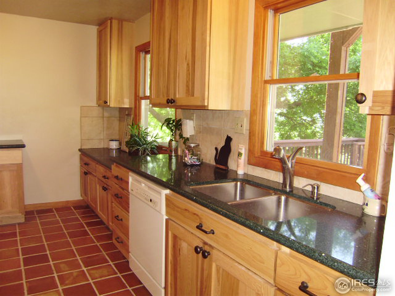 9568 Phillips Road Lafayette, CO 80026 - Photo 13 of 18 a large kitchen with kitchen island granite countertop a large window in it