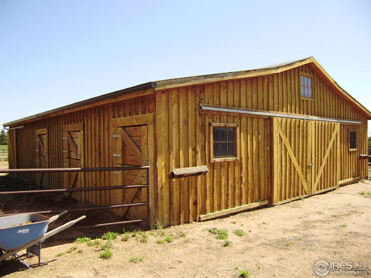 9568 Phillips Road Lafayette, CO 80026 - Photo 3 of 18 a view of wooden house with a wooden fence