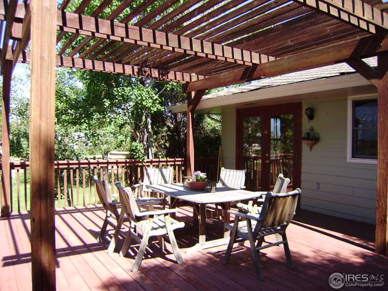 9568 Phillips Road Lafayette, CO 80026 - Photo 8 of 18 a view of a patio with table and chairs floor to ceiling window with wooden floor