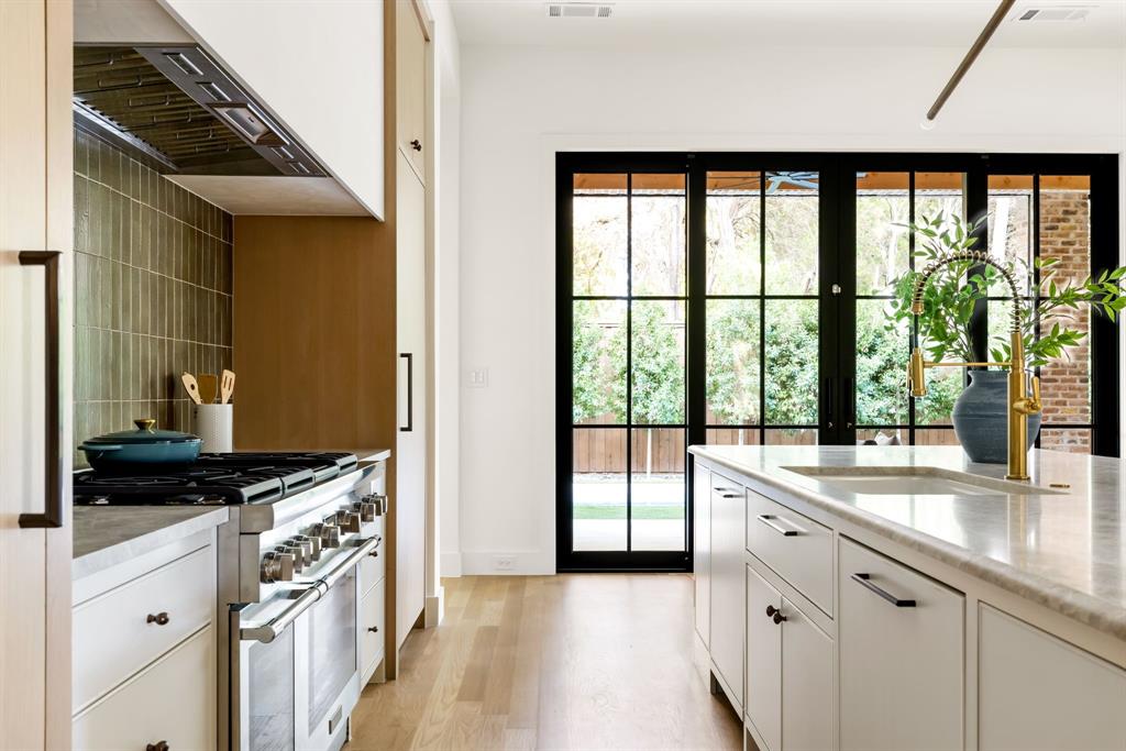 3944 Dalgreen Drive Dallas, TX 75214 - Photo 14 of 38 a kitchen with granite countertop a sink and a refrigerator