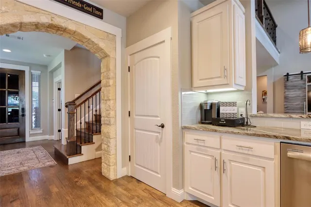 a kitchen with stainless steel appliances granite countertop a refrigerator a stove and a sink