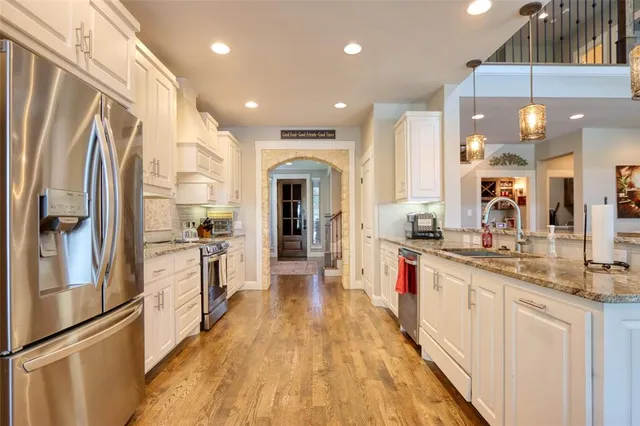 a large kitchen with stainless steel appliances lots of counter top space
