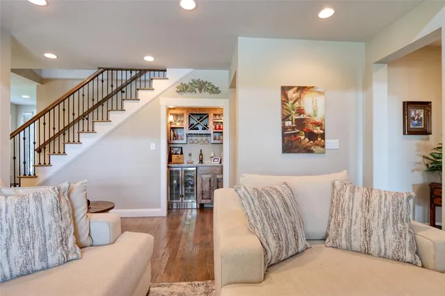 a living room with furniture and stairs