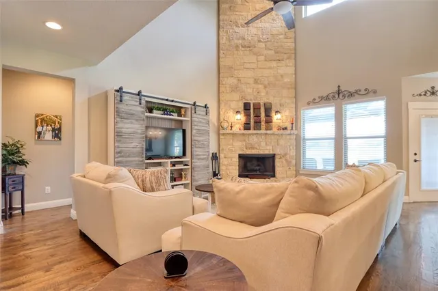 a living room with furniture fireplace and a large window