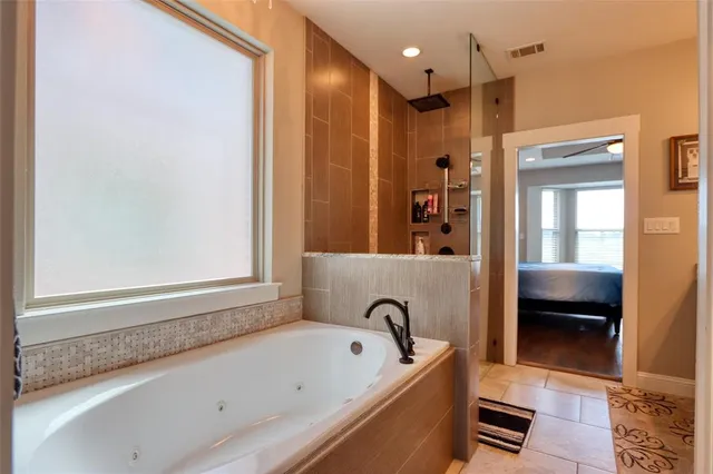 a bathroom with a tub a sink and a shower