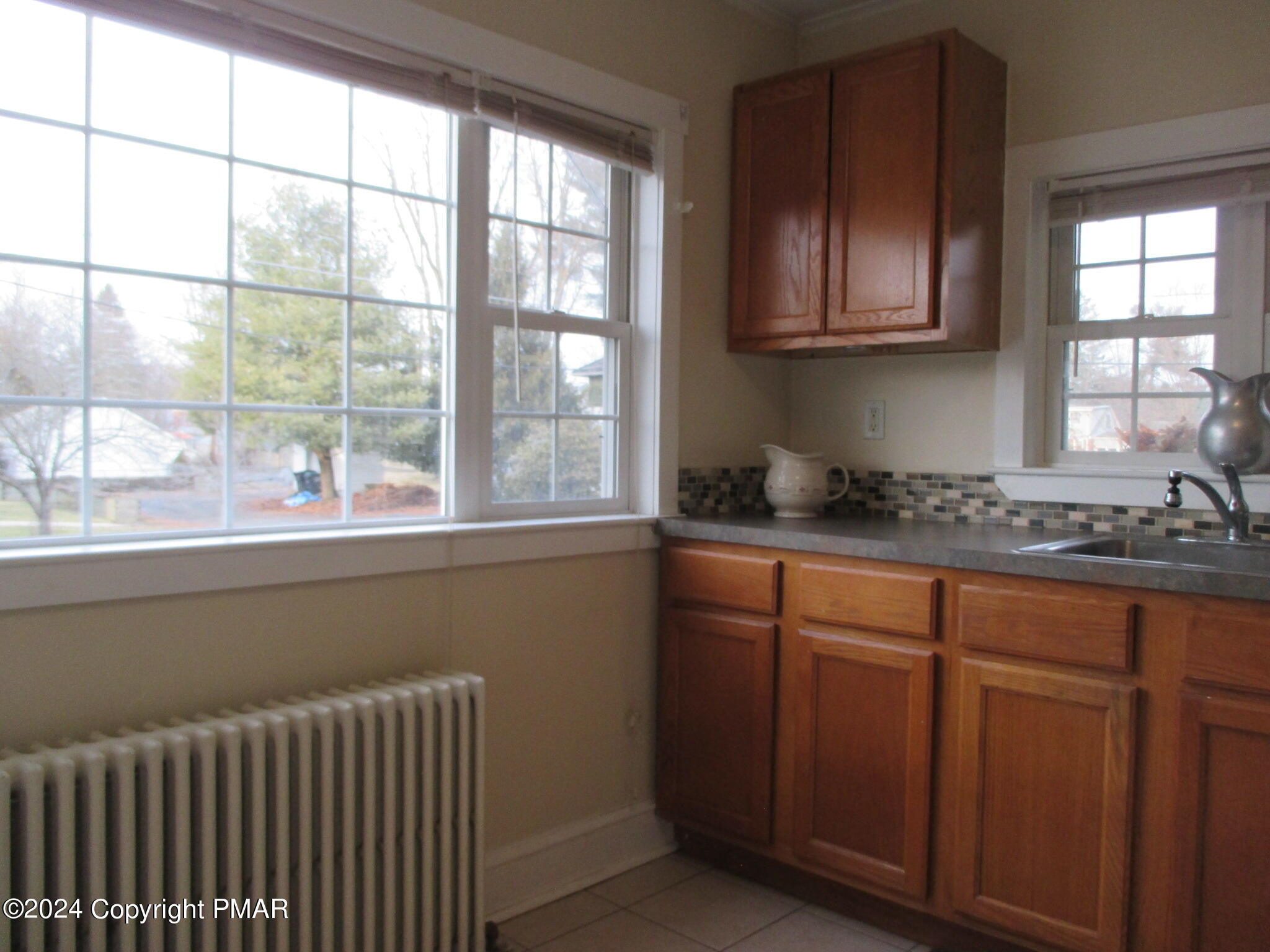 128 Broad Street Stroudsburg, PA 18360 - Photo 12 of 18 a kitchen with stainless steel appliances wooden cabinets a sink and a window