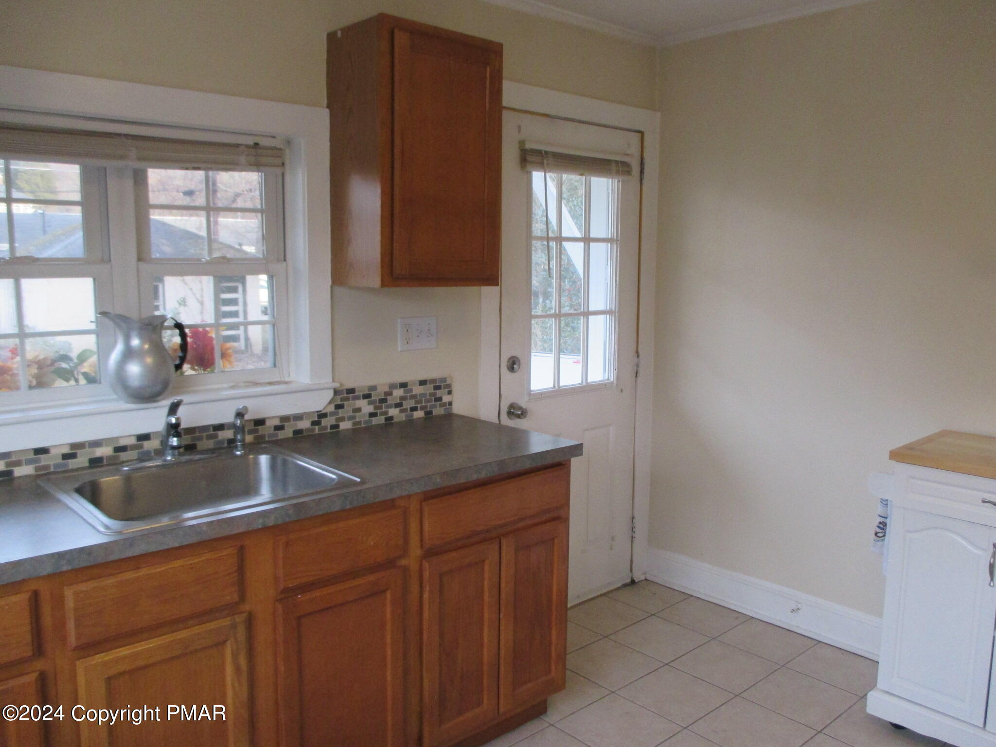 128 Broad Street Stroudsburg, PA 18360 - Photo 14 of 18 a kitchen with granite countertop a sink and a window