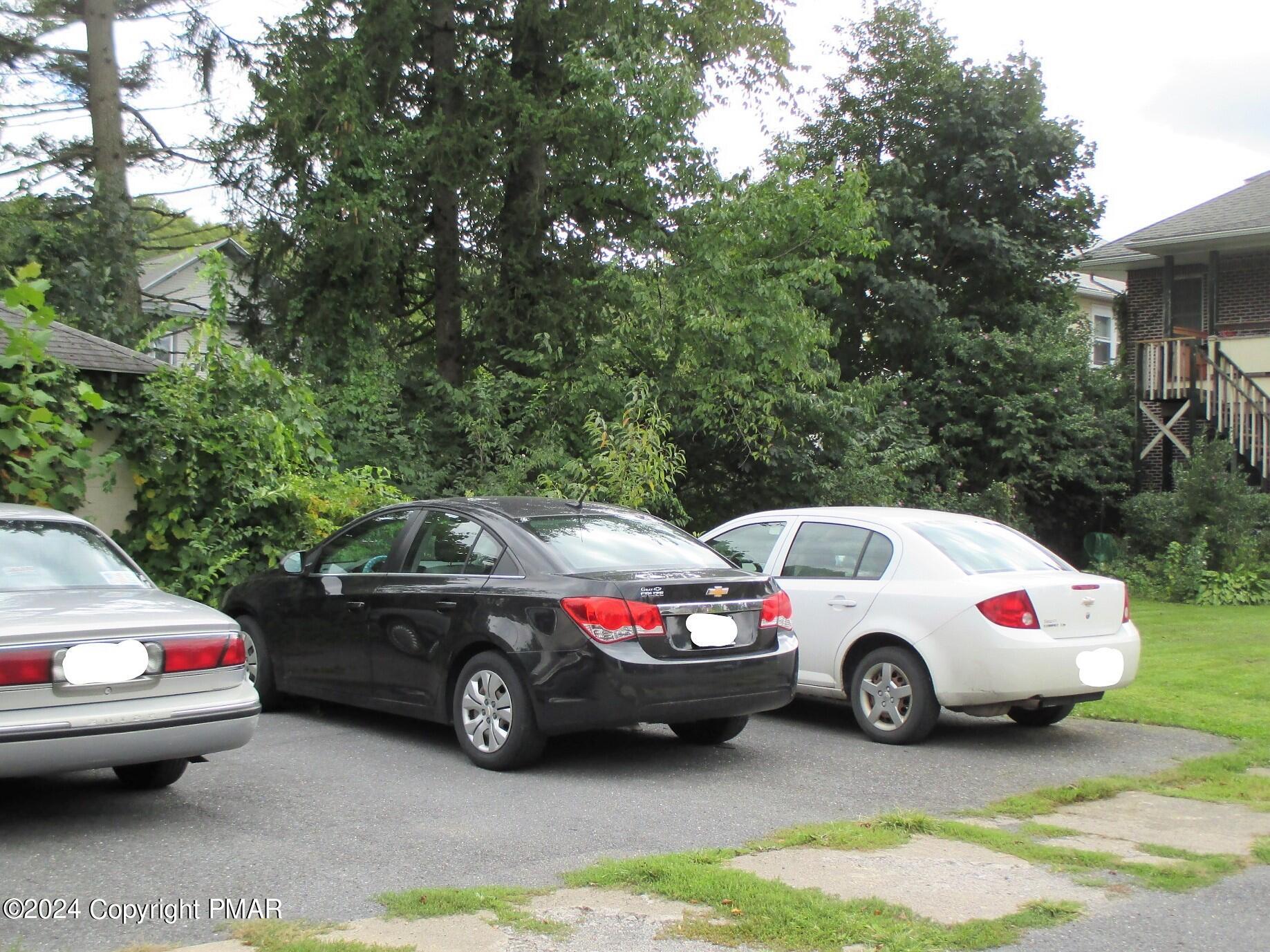 128 Broad Street Stroudsburg, PA 18360 - Photo 18 of 18 a white house covered with tall trees
