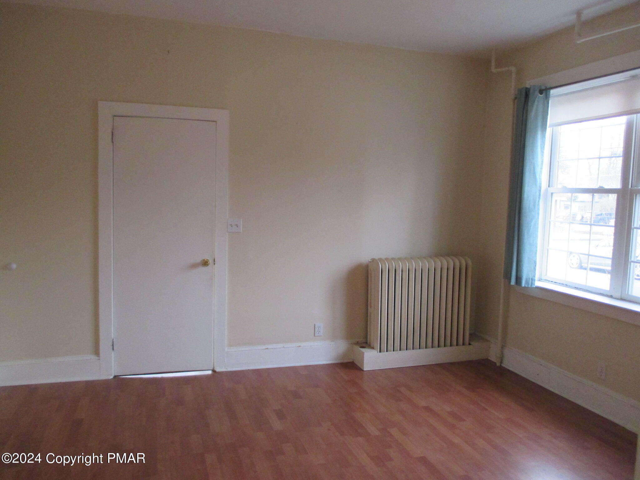 128 Broad Street Stroudsburg, PA 18360 - Photo 10 of 18 an empty room with wooden floor and windows