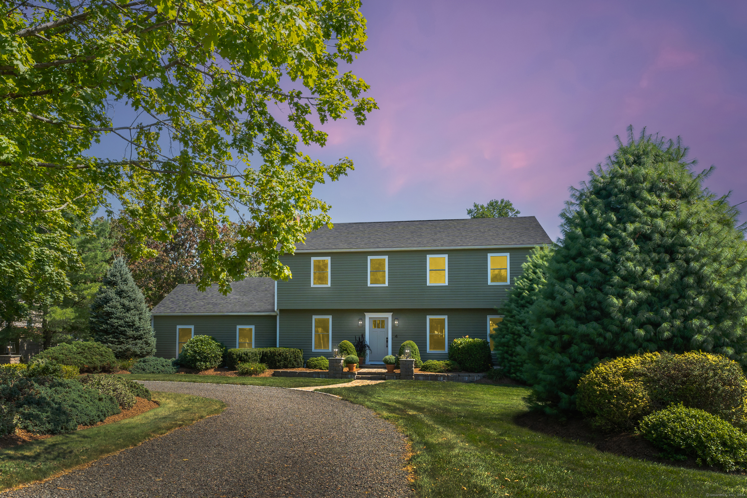 a front view of a house with a garden