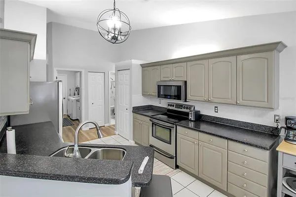 a kitchen with stainless steel appliances a sink stove and refrigerator
