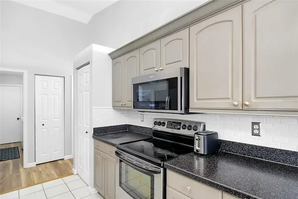 a bathroom with a granite countertop sink mirror and toilet