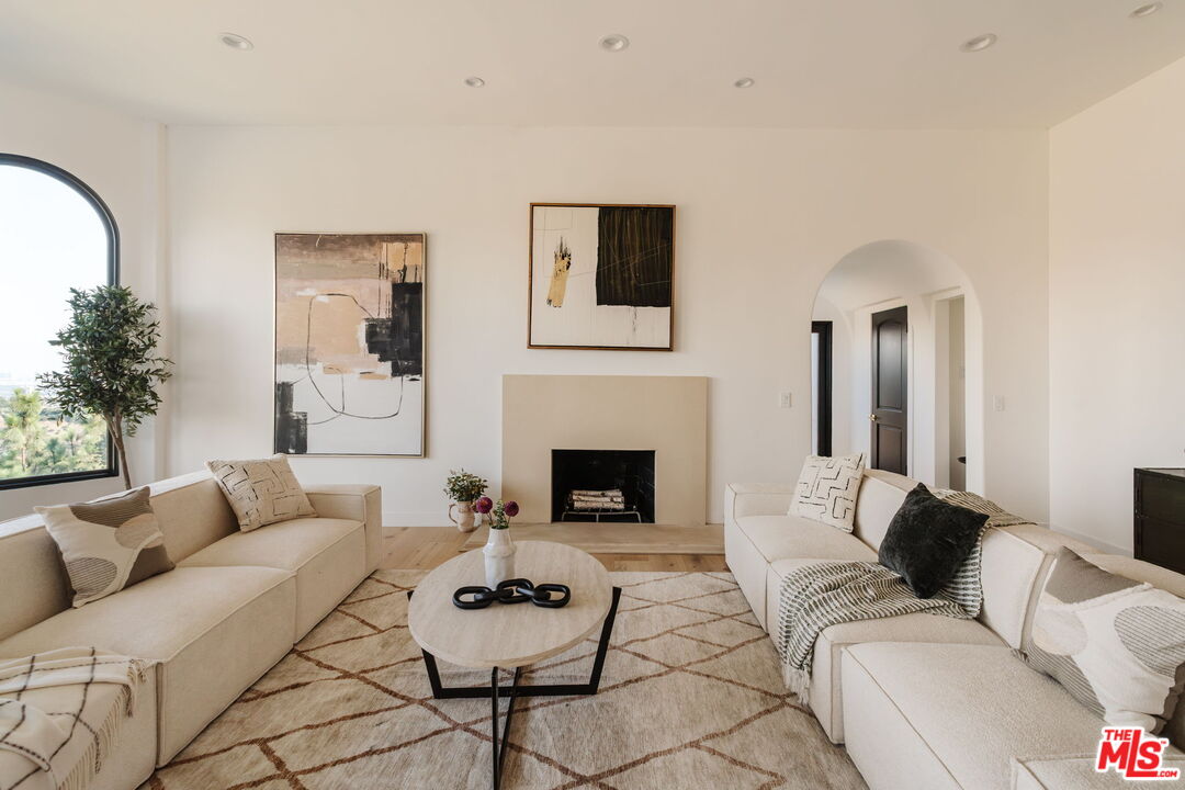 1666 Summitridge Drive Beverly Hills, CA 90210 - Photo 11 of 39 a living room with furniture and a fireplace