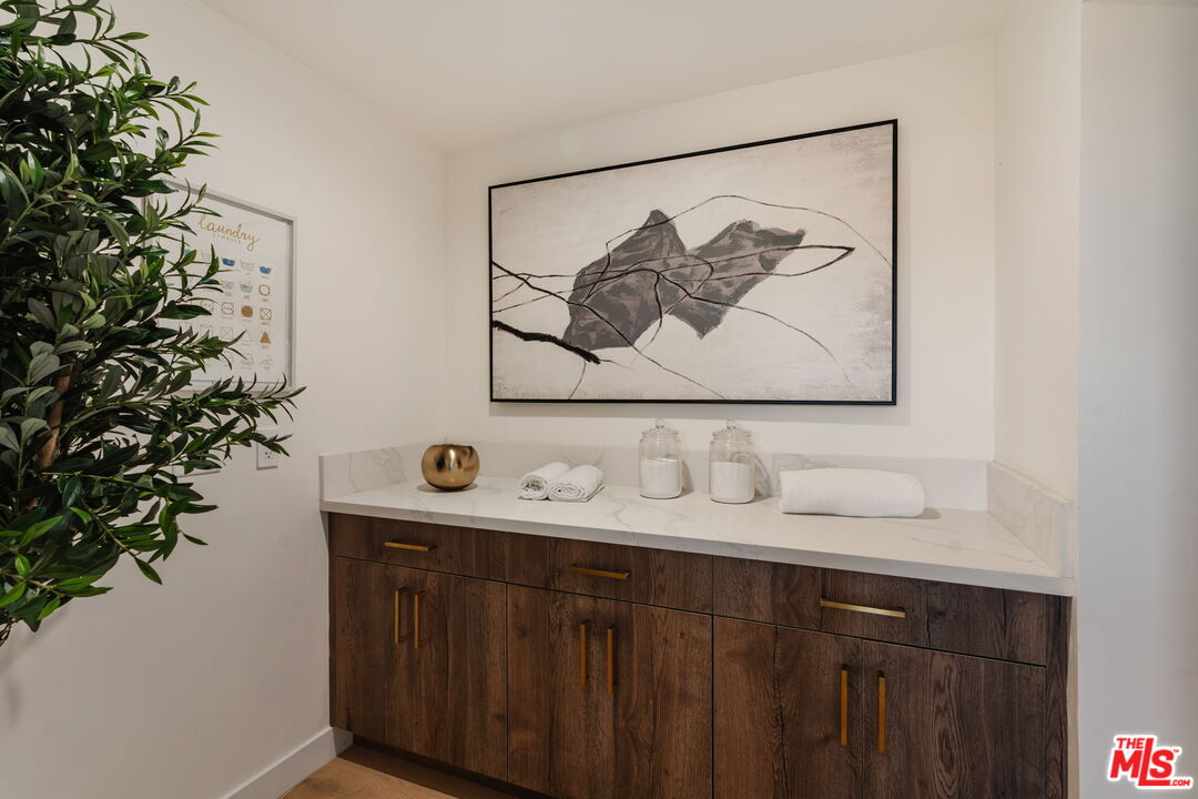 1666 Summitridge Drive Beverly Hills, CA 90210 - Photo 14 of 39 a bathroom with a sink and a mirror