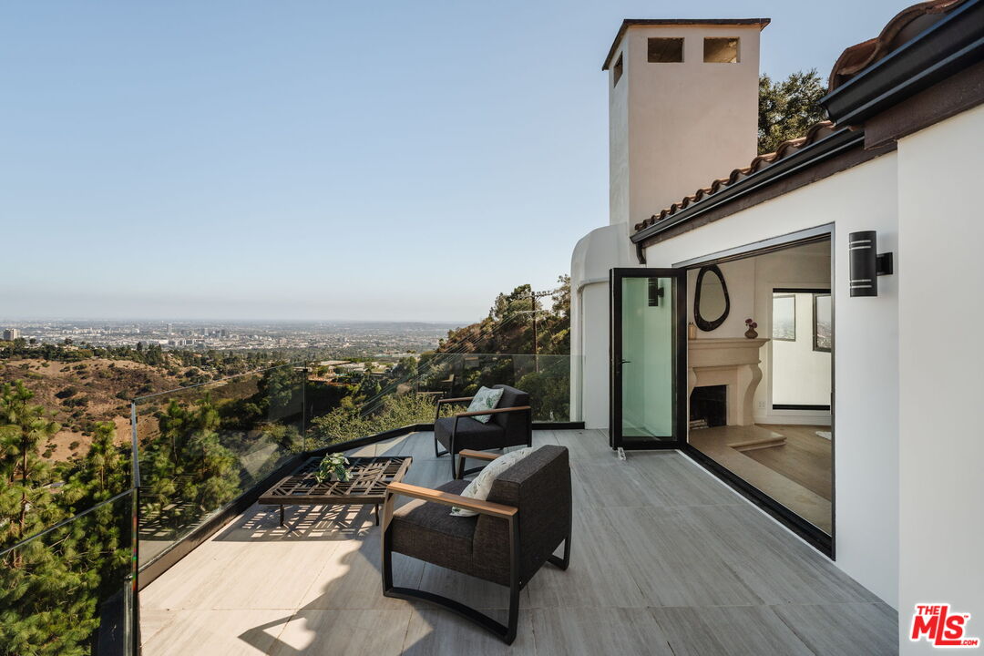 1666 Summitridge Drive Beverly Hills, CA 90210 - Photo 18 of 39 a view of a couches in the balcony