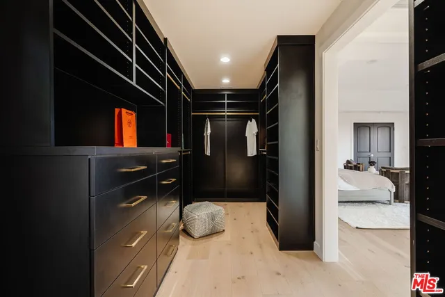 a kitchen with a refrigerator and a television