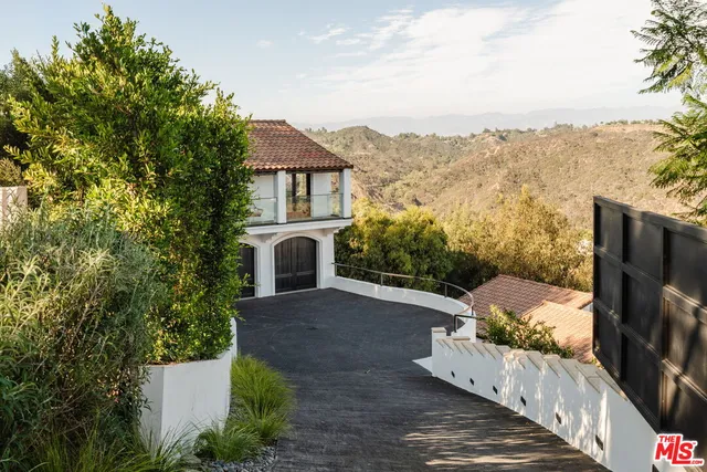 a view of a terrace with a garden and mountain view