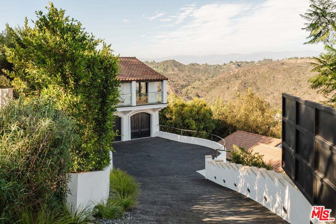 1666 Summitridge Drive Beverly Hills, CA 90210 - Photo 2 of 39 a view of a terrace with a garden and mountain view