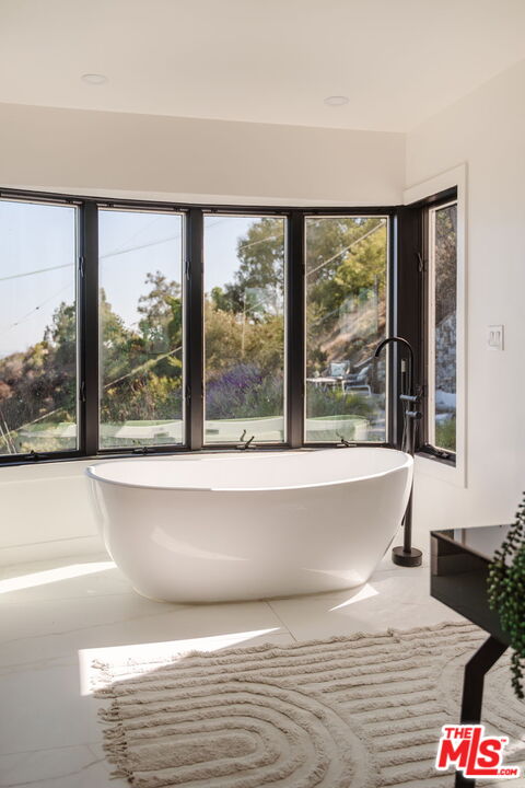 1666 Summitridge Drive Beverly Hills, CA 90210 - Photo 21 of 39 a living room with a large window