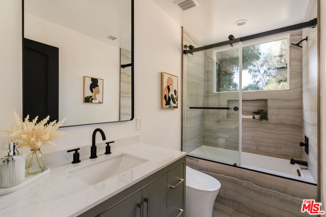 1666 Summitridge Drive Beverly Hills, CA 90210 - Photo 26 of 39 a bathroom with a sink toilet and shower