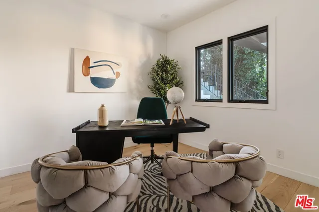 a white house with a big yard and plants