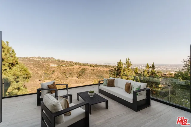a view of a terrace with couches and sky view