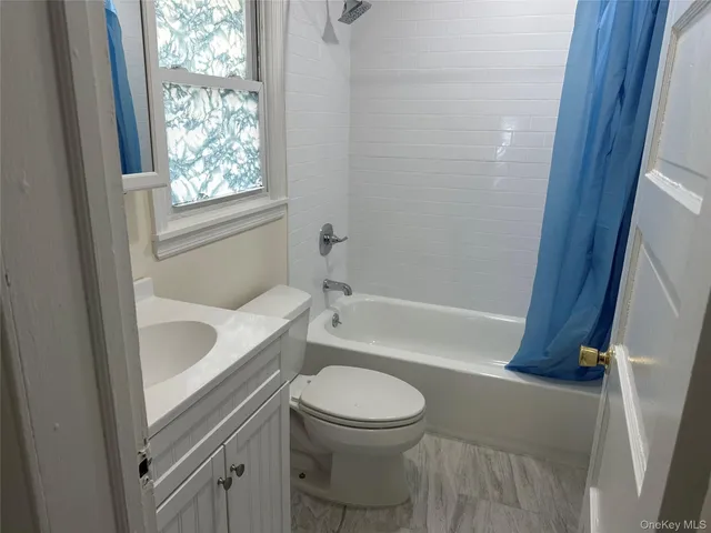a bathroom with a toilet a sink and bathtub