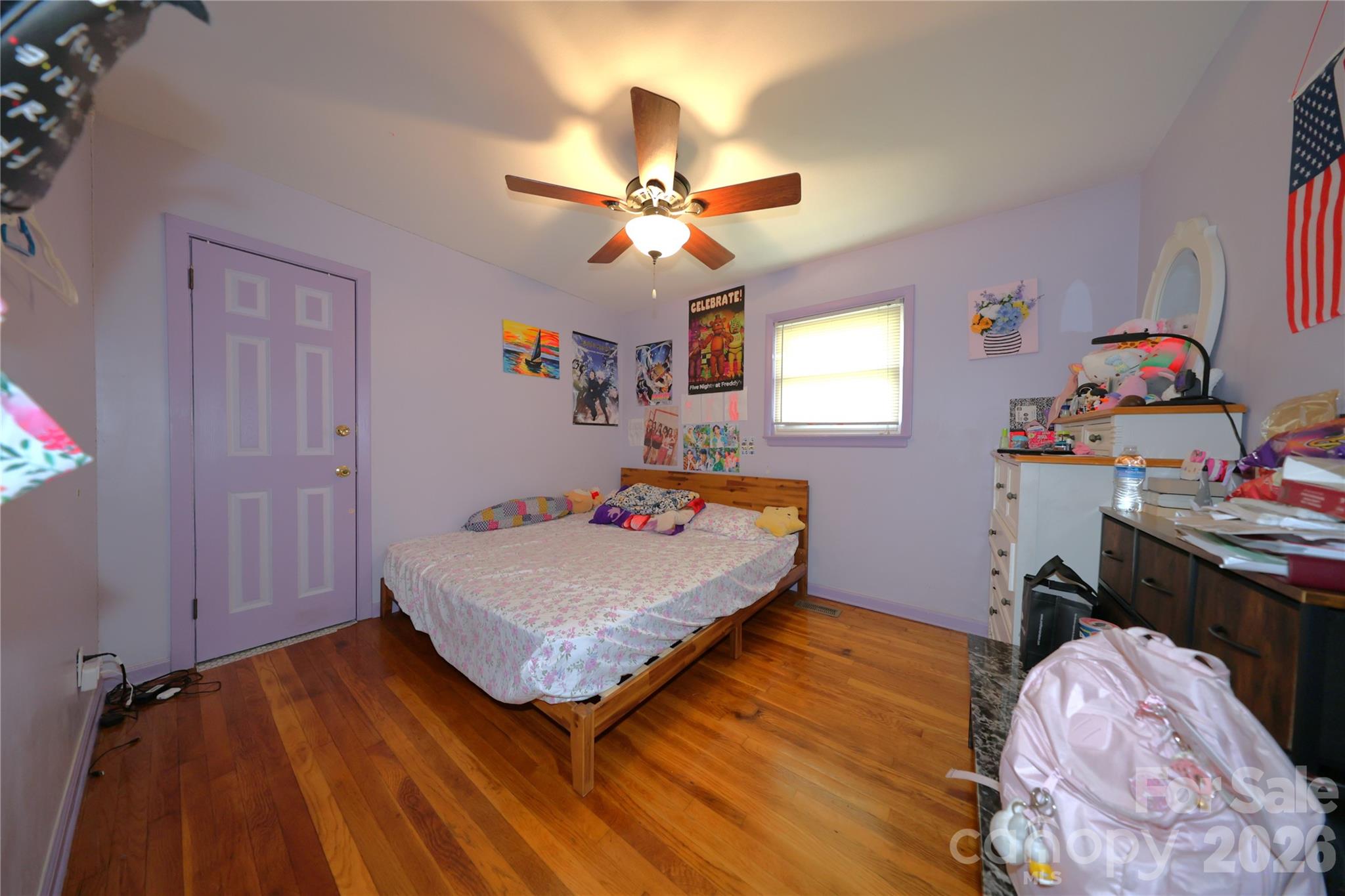104 Pinetree Drive Matthews, NC 28104 - Photo 3 of 6 a bedroom with a bed and a chandelier