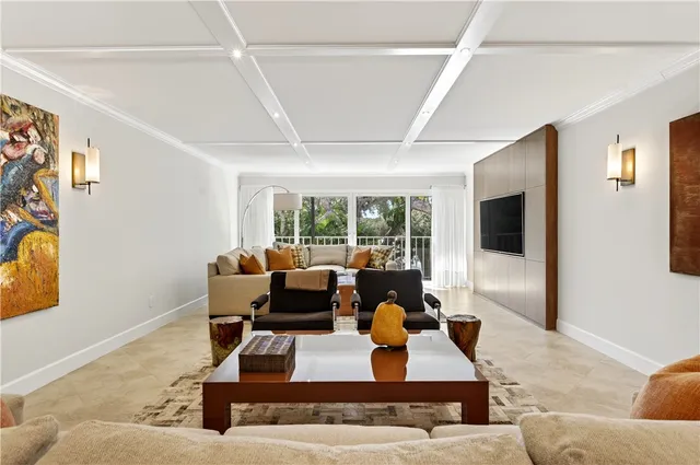 a living room with furniture a couch and a large window