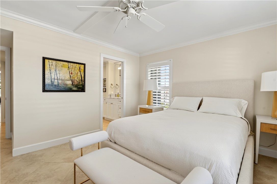 2743 Ocean Drive, Unit 50E Vero Beach, FL 32963 - Photo 26 of 36 a bedroom with a bed and a chandelier