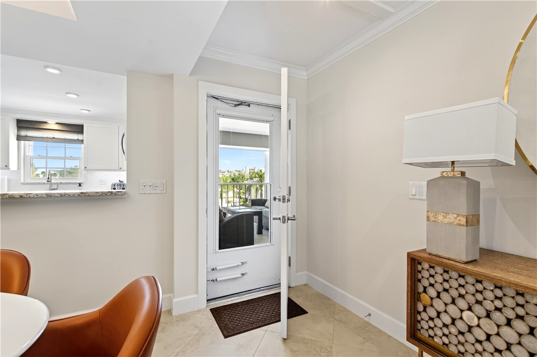 2743 Ocean Drive, Unit 50E Vero Beach, FL 32963 - Photo 28 of 36 a room with furniture a rug and a window